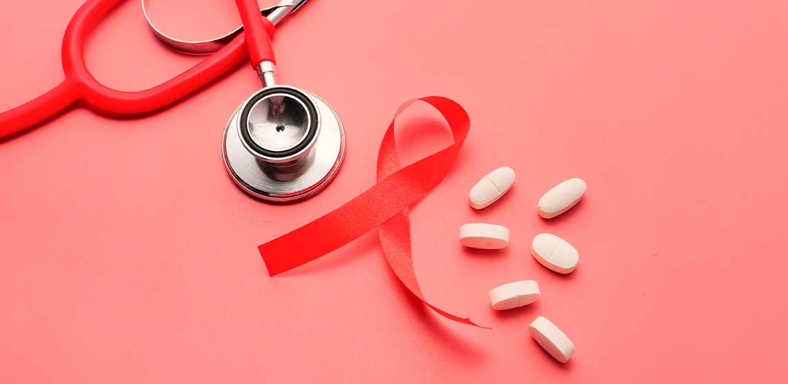 A red stethoscope, a red ribbon, and pills against a red background.